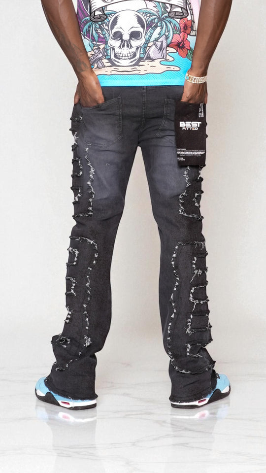 Person wearing a graphic t-shirt and distressed jeans on a white background
