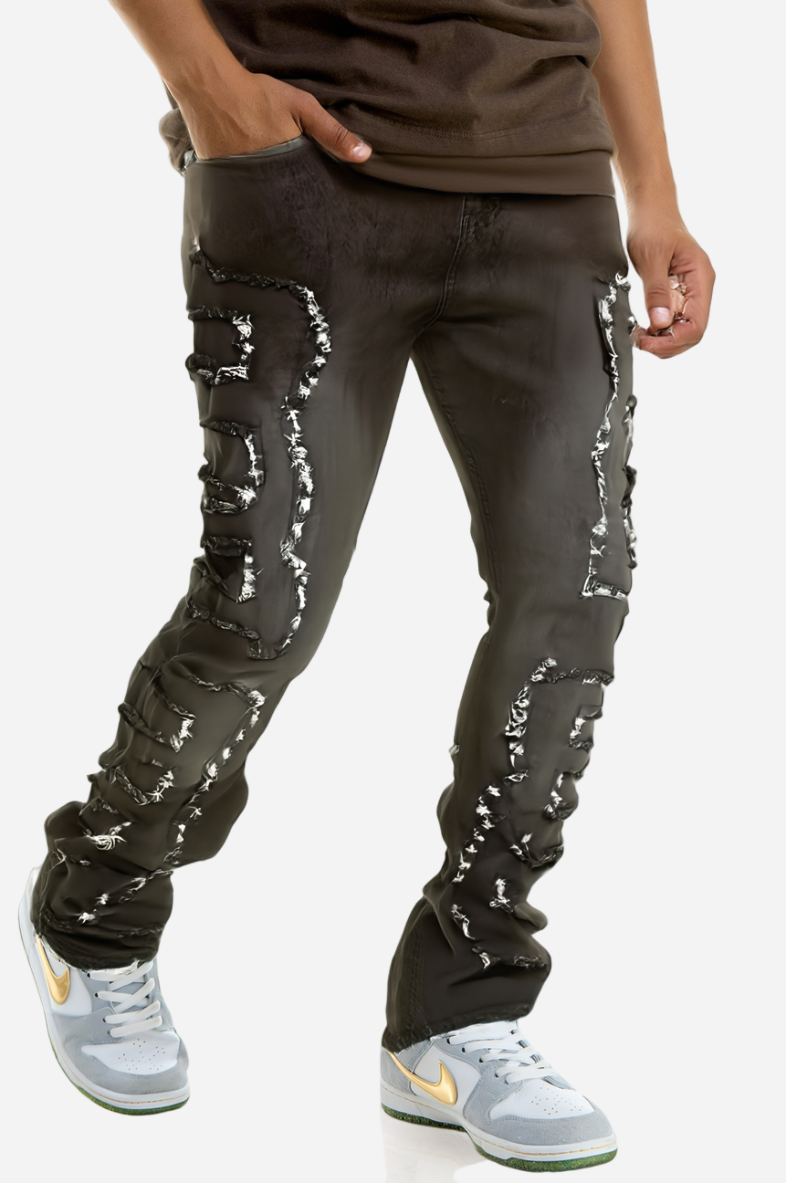 Person wearing black pants with white distressed designs on a white background