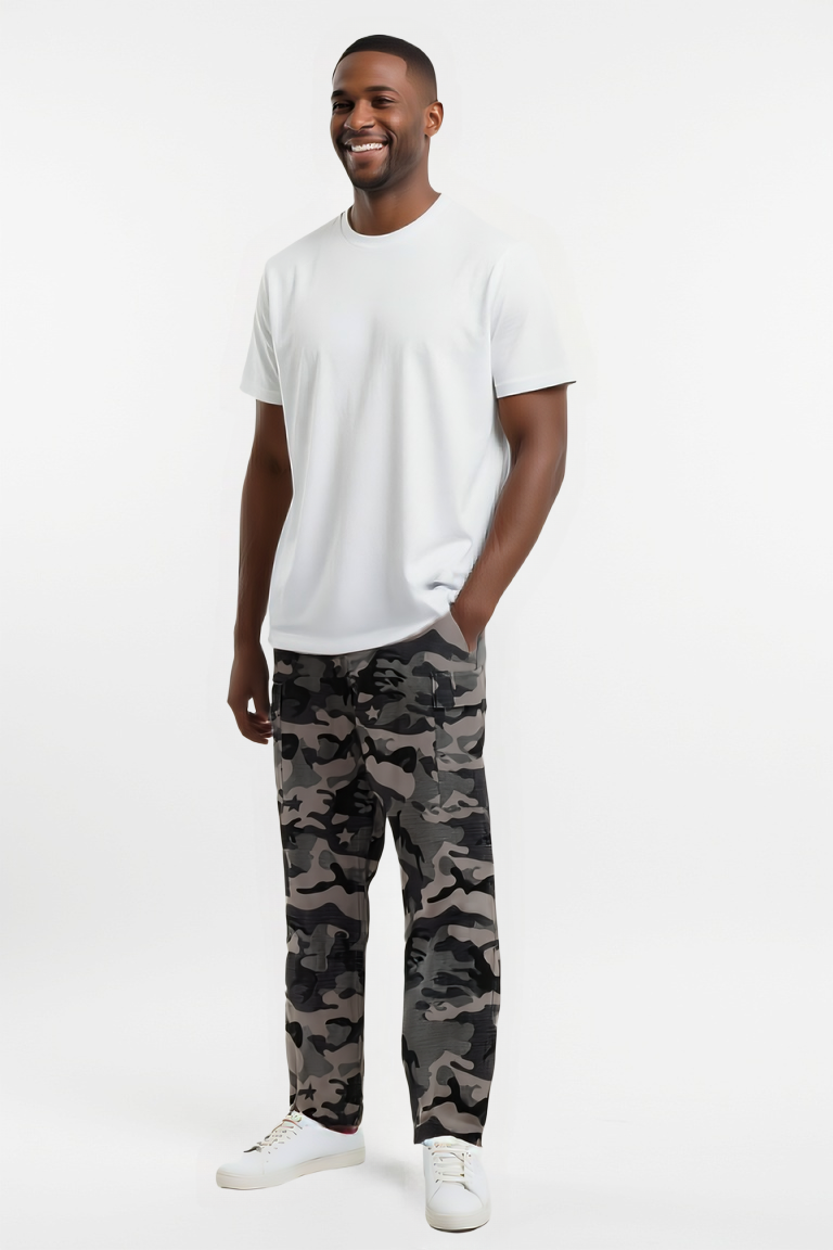 Man wearing a white t-shirt and camouflage pants on a white background